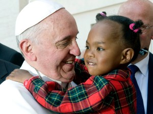 Pope Francis greets a child after celebrating Mass on the feast of Pentecost in St. Peter's Square at the Vatican May 19. (CNS photo/Alessia Giuliani, Catholic Press Photo) (May 20, 2013) See POPE-PENTECOST May 20, 2013.